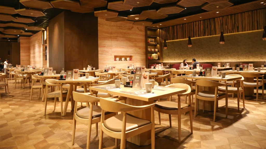 Restaurant interior with dining chairs and tables arranged for commercial use