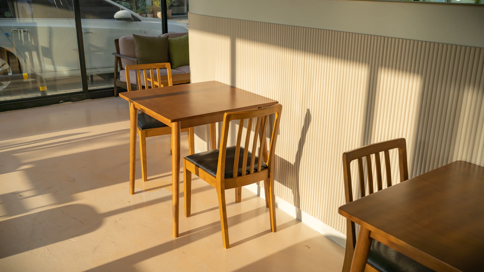 Wooden dining chairs and table shown as a coordinated furniture collection