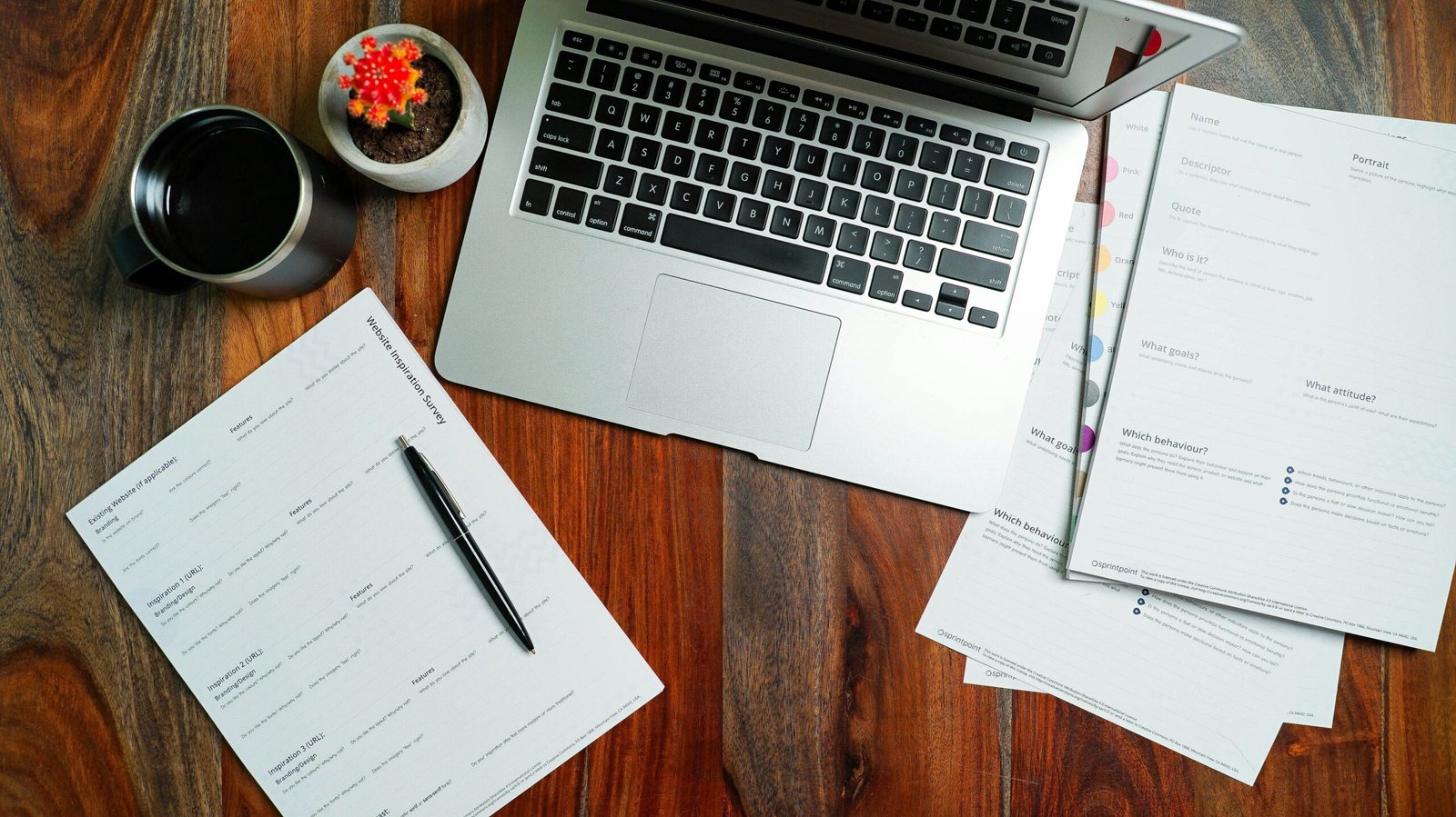 Buyer preparing a furniture RFQ with documents and a laptop