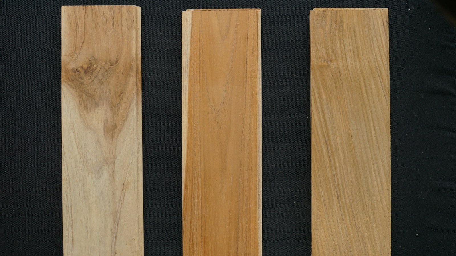 Natural hardwood boards showing contrasting grain patterns for wood species comparison