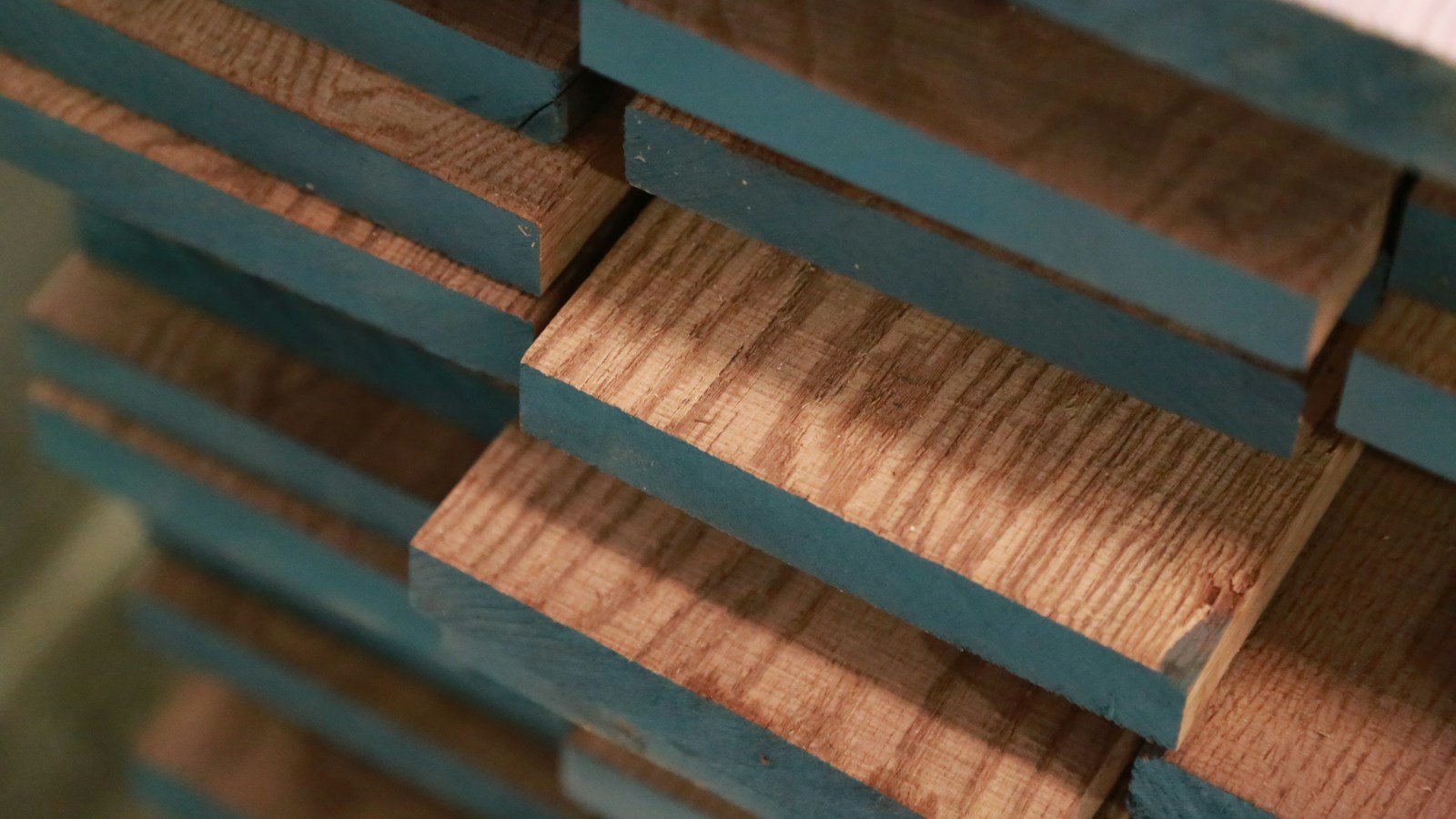 Stacked hardwood timber showing visible grain and natural color variation